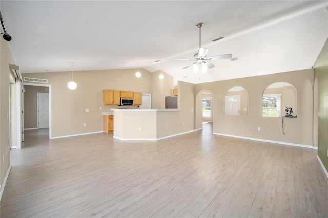 unfurnished living room featuring ceiling fan, vaulted ceiling, and light hardwood / wood-style floors