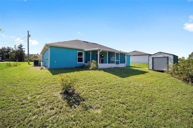 view of front facade featuring a storage shed, central AC, and a front lawn