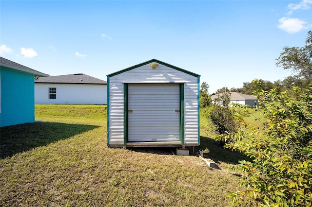 view of outbuilding featuring a yard