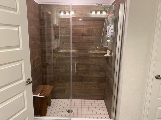 bathroom featuring a shower with door