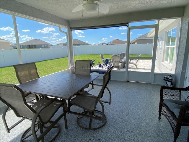 sunroom featuring ceiling fan