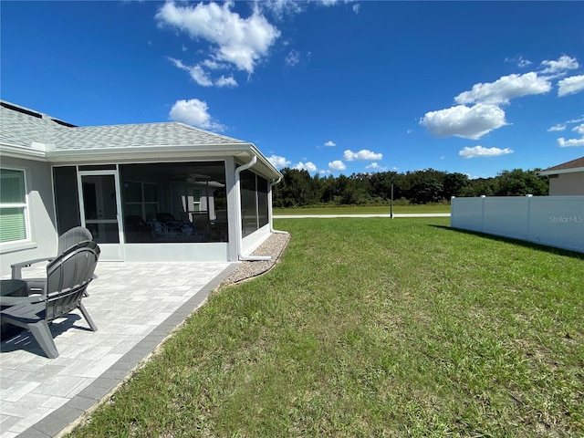 view of yard with a patio area and a sunroom