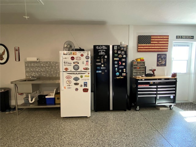 kitchen with black fridge and white fridge