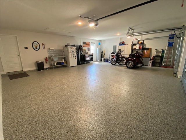 garage with white refrigerator and a garage door opener