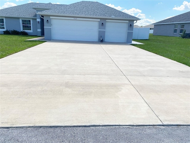 view of front of house featuring a garage and a front lawn