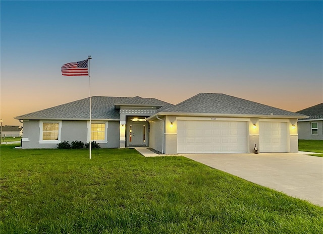 prairie-style home featuring a yard and a garage