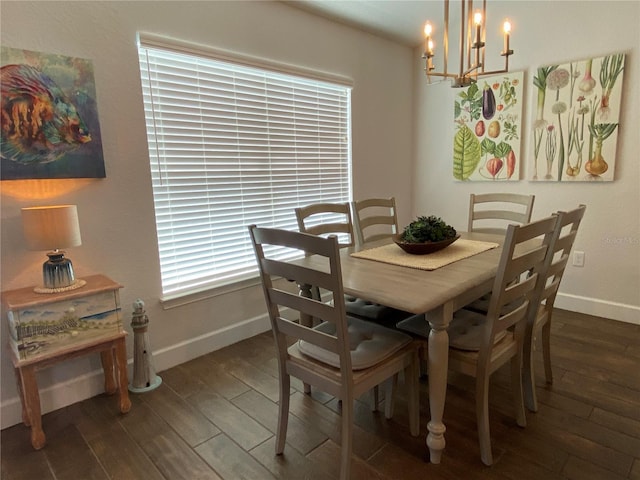 dining space featuring dark wood-type flooring and a chandelier