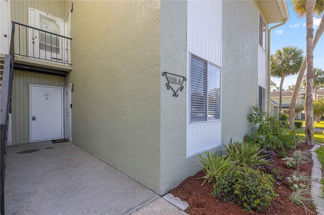 551 Fairways Dr Unit A, Ocala, FL 34472 - view of exterior entry featuring stucco siding and a balcony