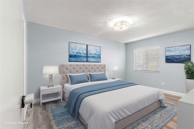 bedroom featuring a textured ceiling and hardwood / wood-style flooring