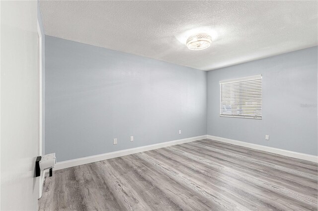 551 Fairways Dr Unit A, Ocala, FL 34472 - unfurnished room featuring baseboards, wood finished floors, and a textured ceiling