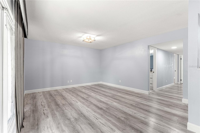 551 Fairways Dr Unit A, Ocala, FL 34472 - empty room with a textured ceiling, light wood-style flooring, and baseboards
