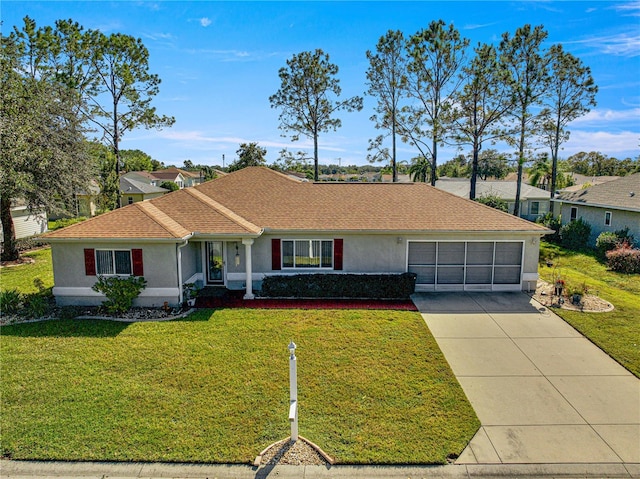 single story home with a garage and a front lawn