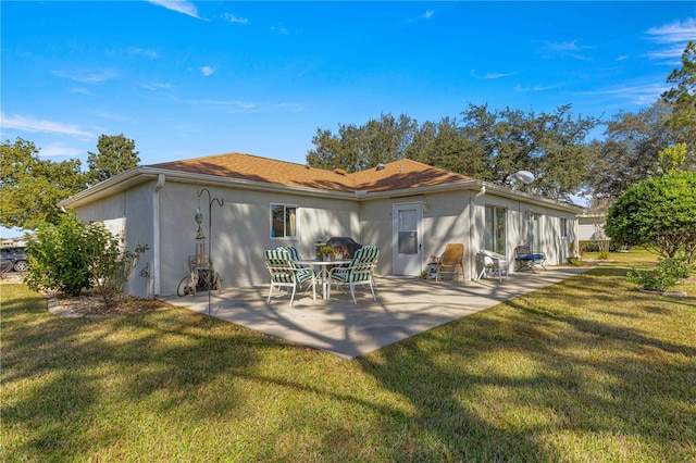 rear view of property with a patio area and a yard