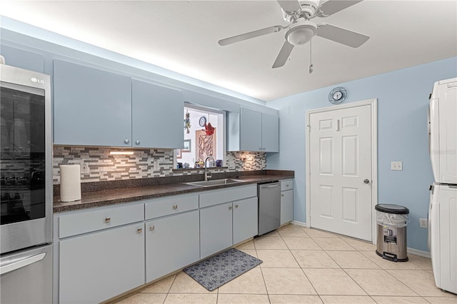 kitchen featuring ceiling fan, appliances with stainless steel finishes, light tile patterned floors, backsplash, and sink