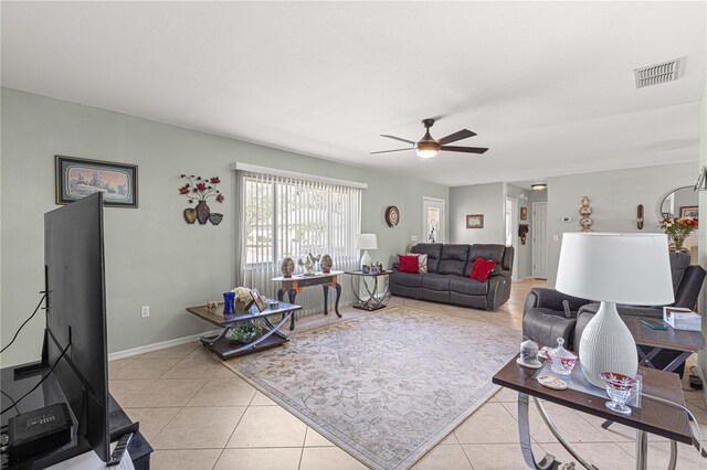 living room with ceiling fan and light tile patterned floors