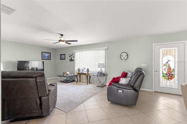 tiled living room featuring ceiling fan