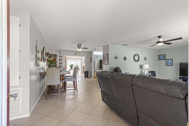 tiled living room with ceiling fan