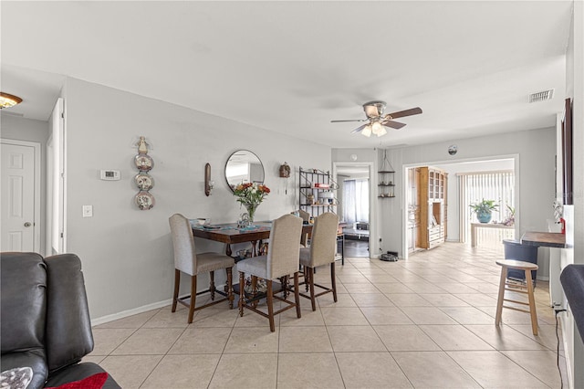 tiled dining area featuring ceiling fan