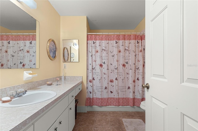 full bathroom featuring vanity, shower / bath combination with curtain, toilet, and tile patterned flooring