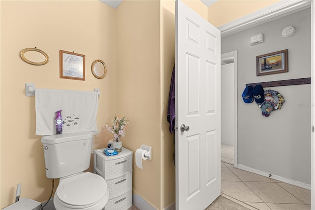 bathroom with toilet and tile patterned floors