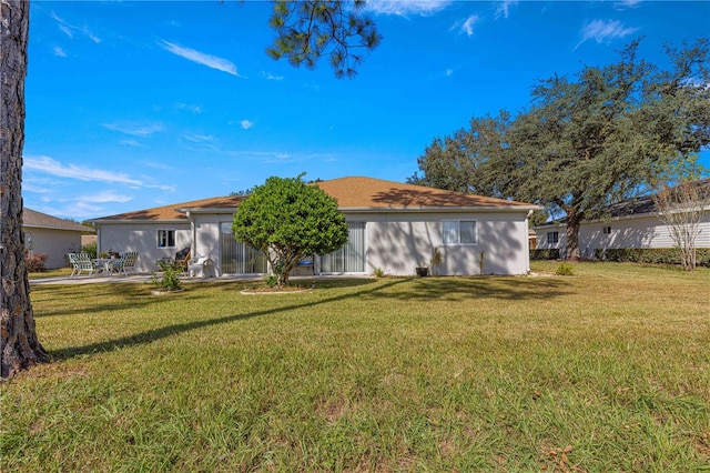 rear view of property with a yard