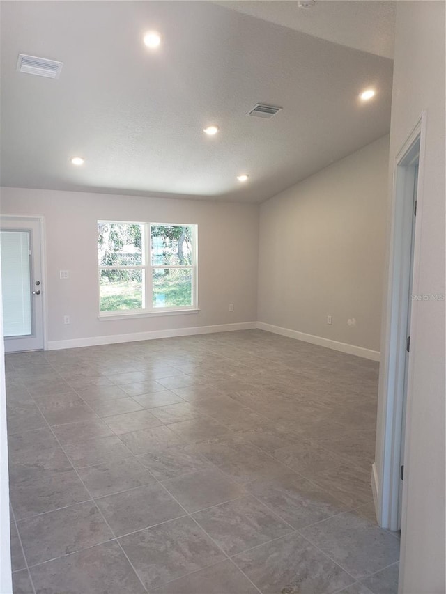 tiled spare room featuring baseboards, visible vents, and recessed lighting