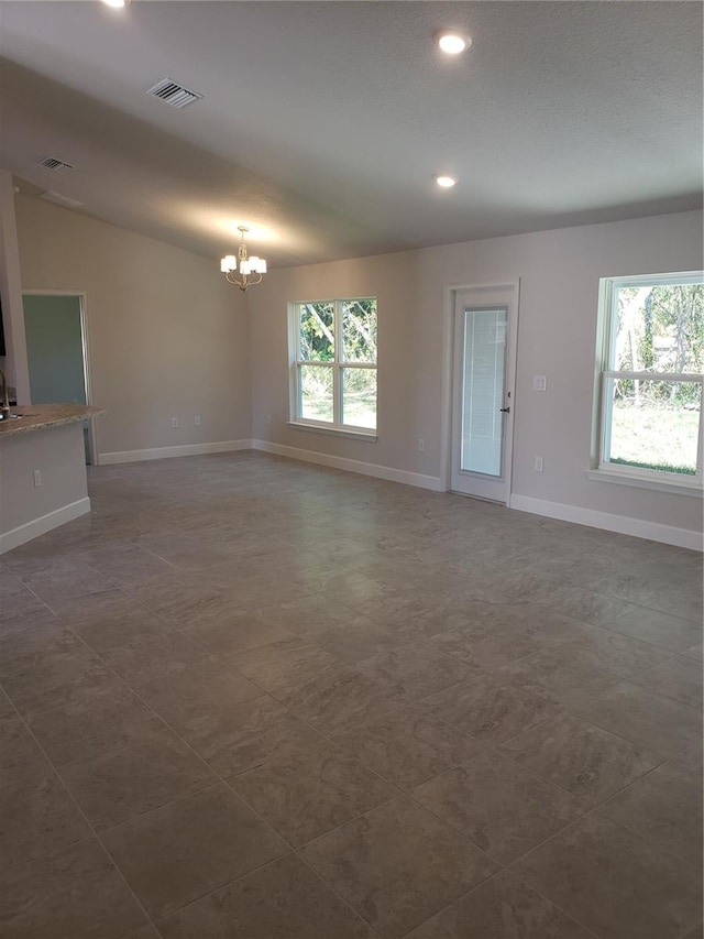 empty room with recessed lighting, a notable chandelier, a sink, visible vents, and baseboards