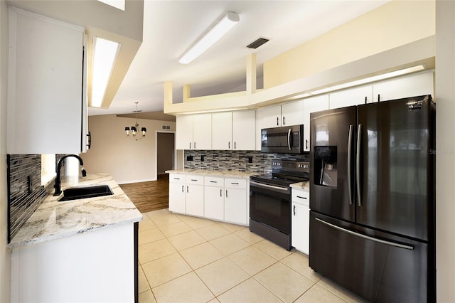 kitchen with pendant lighting, sink, decorative backsplash, white cabinets, and appliances with stainless steel finishes