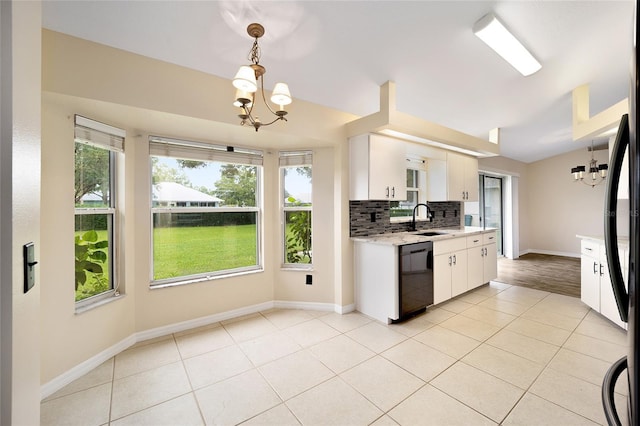 kitchen with plenty of natural light, hanging light fixtures, black dishwasher, and white cabinets