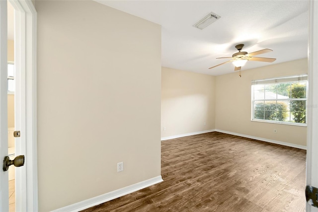 unfurnished room with ceiling fan and dark hardwood / wood-style flooring