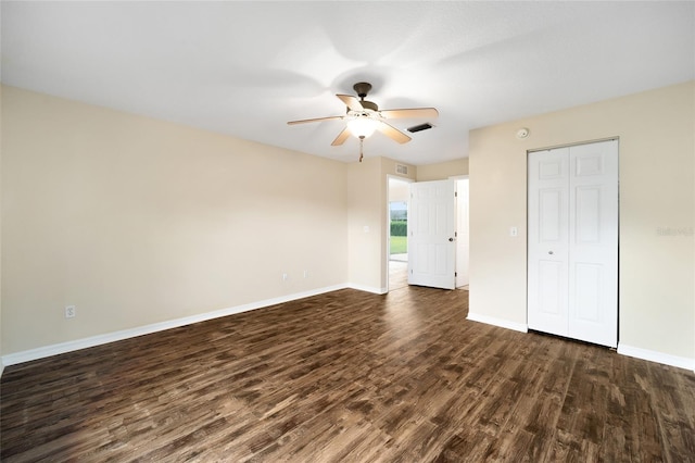 unfurnished bedroom with ceiling fan, a closet, and dark hardwood / wood-style flooring