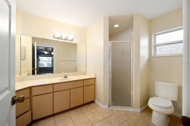 bathroom featuring vanity, toilet, a shower with door, and a healthy amount of sunlight