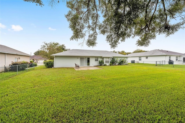 rear view of house featuring a lawn and a patio area