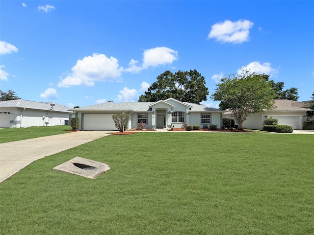 ranch-style home with an attached garage, a front lawn, stucco siding, and driveway
