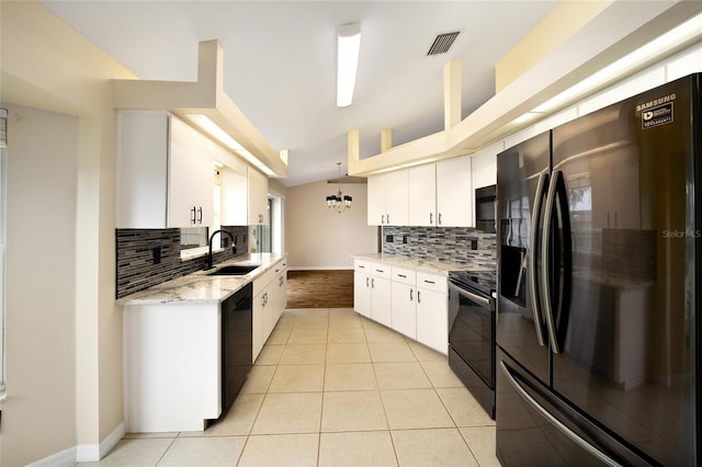 kitchen with light tile patterned flooring, white cabinets, a sink, backsplash, and black appliances