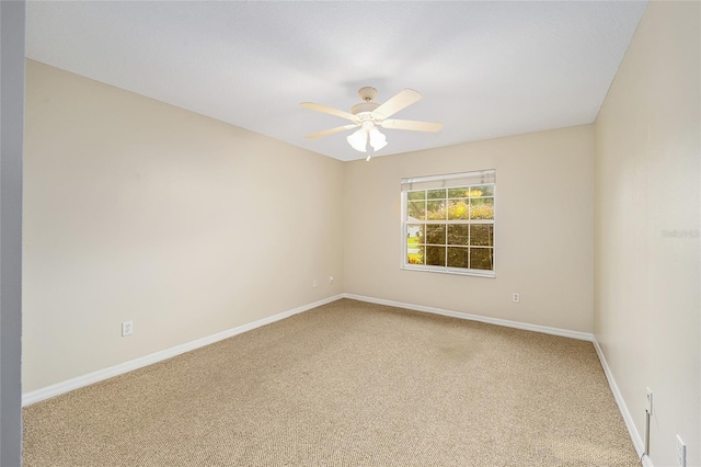 empty room featuring carpet floors, baseboards, and a ceiling fan