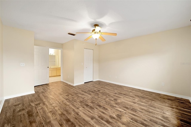 spare room with baseboards, a ceiling fan, wood finished floors, and visible vents