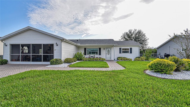 single story home with a sunroom and a front yard