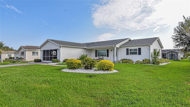 ranch-style home with a sunroom and a front lawn