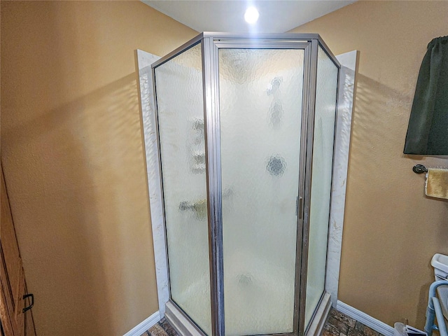 bathroom with a shower with shower door