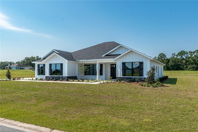 2073 NW 79th Loop, Ocala, FL 34475 - modern farmhouse style home featuring board and batten siding, a front yard, and roof with shingles
