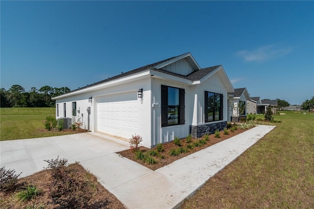 view of side of home with a yard, cooling unit, and a garage