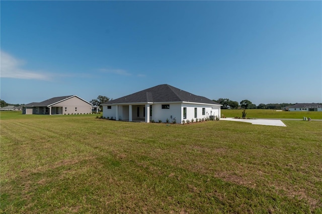 back of property featuring a yard