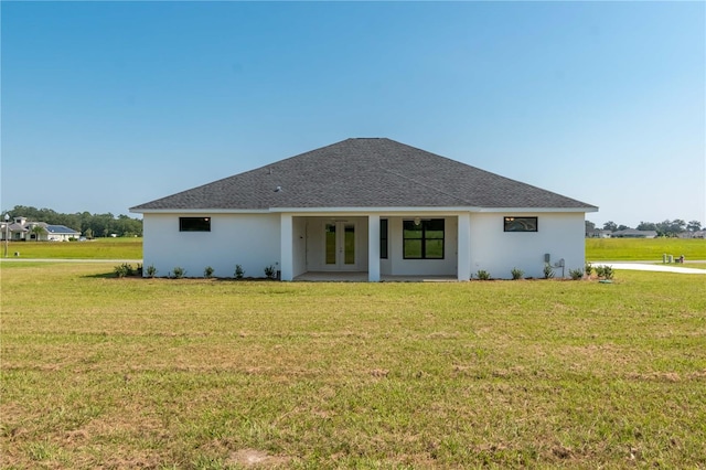 2073 NW 79th Loop, Ocala, FL 34475 - view of front of home featuring french doors, a front lawn, stucco siding, and a shingled roof