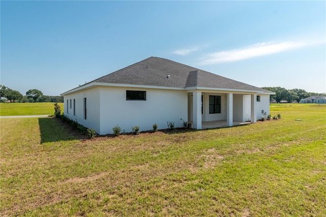 rear view of house featuring a yard