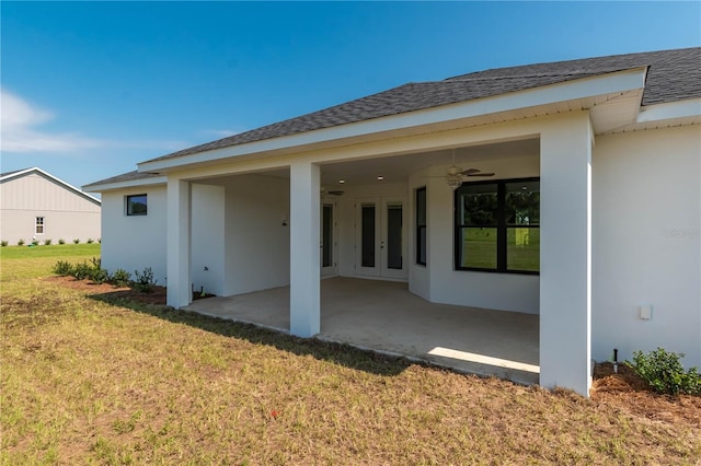 back of property featuring a patio, a lawn, and ceiling fan