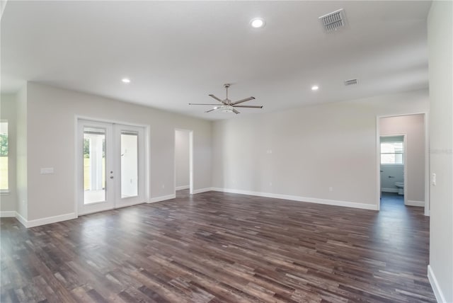 unfurnished room featuring french doors, ceiling fan, a wealth of natural light, and dark hardwood / wood-style flooring