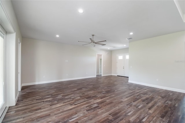 spare room with ceiling fan and dark hardwood / wood-style flooring