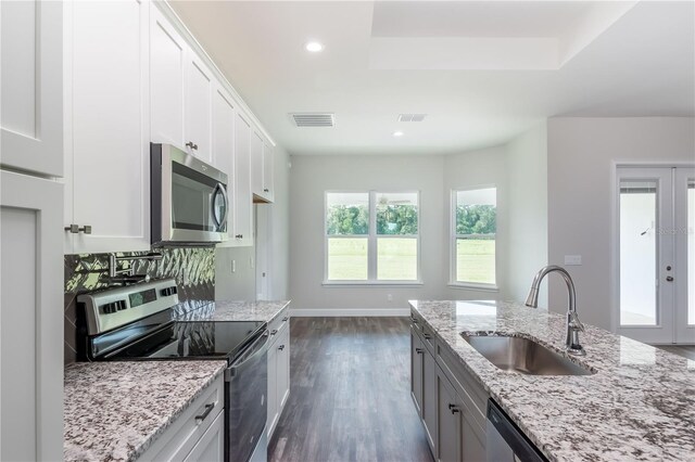 kitchen featuring appliances with stainless steel finishes, sink, and white cabinets