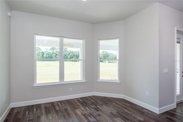 empty room with dark hardwood / wood-style flooring